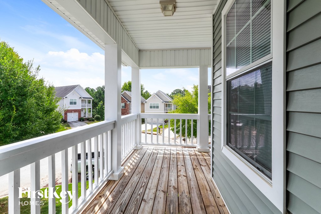 the view from the porch of a home with a wooden deck