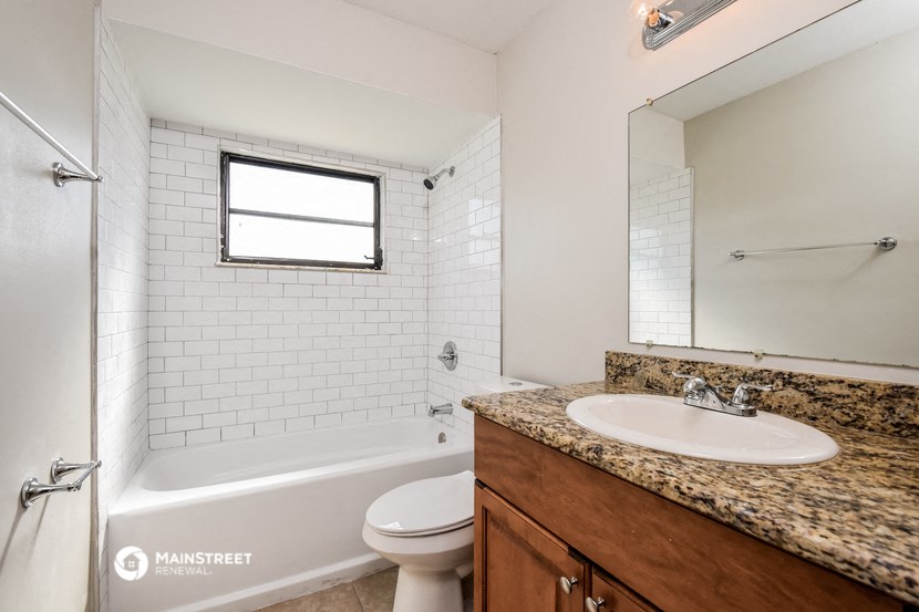 a bathroom with a sink and a toilet and a tub