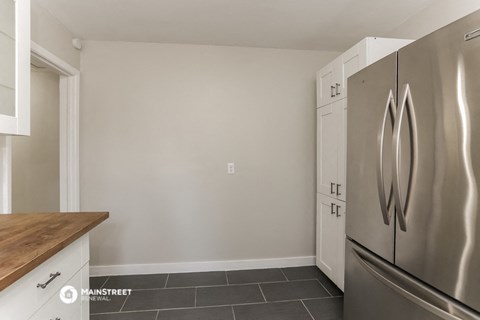 a kitchen with stainless steel appliances and a wooden counter top