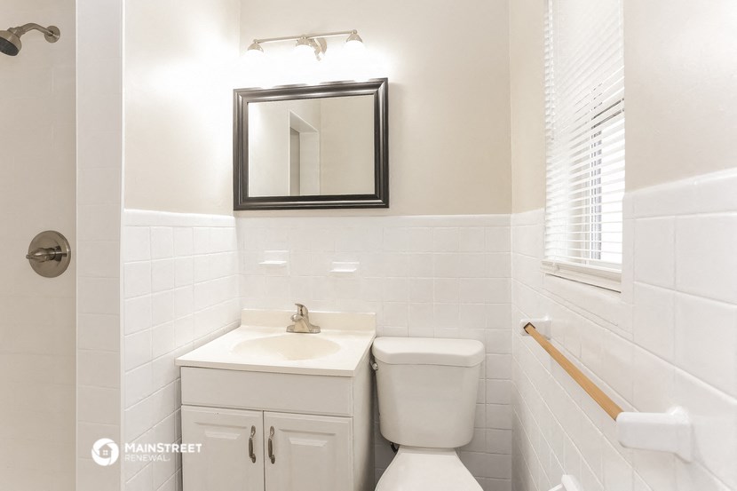 a bathroom with a sink and a toilet and a mirror