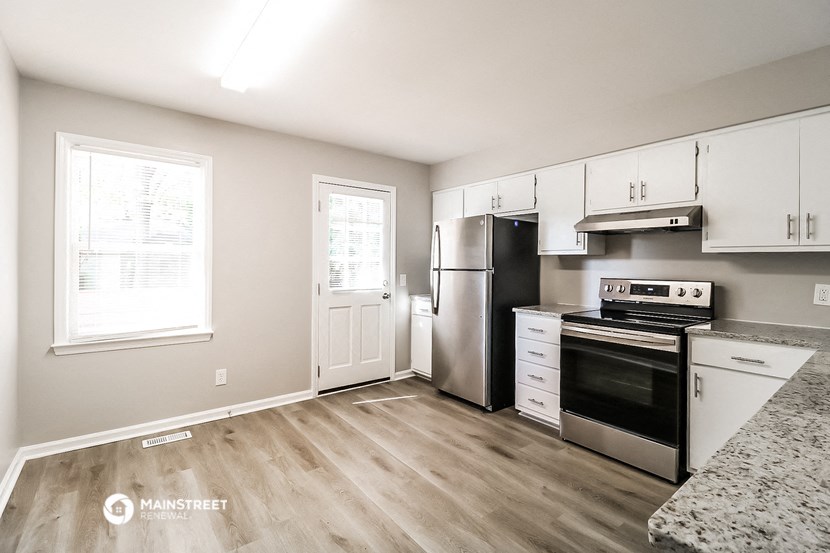 a kitchen with stainless steel appliances and white cabinets