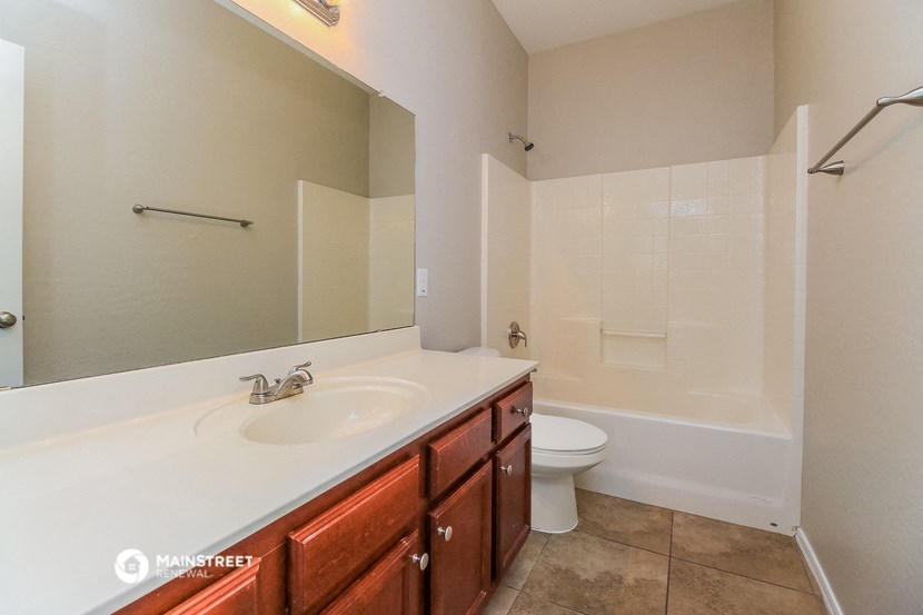 a bathroom with a sink toilet and a mirror