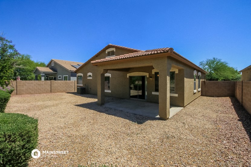 a house with a gravel yard and a driveway
