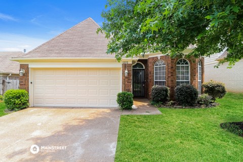 a house with a white garage door and a lawn