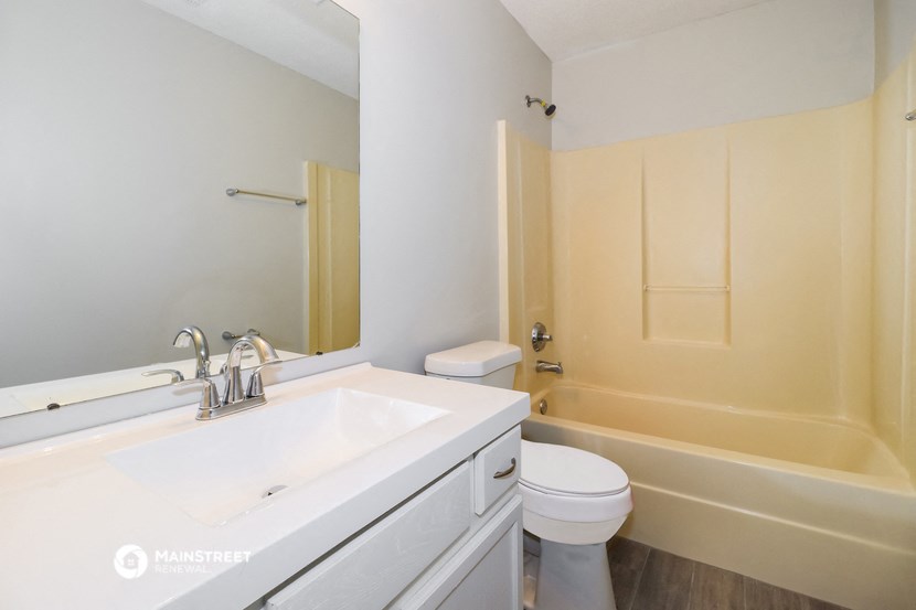 a bathroom with a sink and a toilet and a bath tub