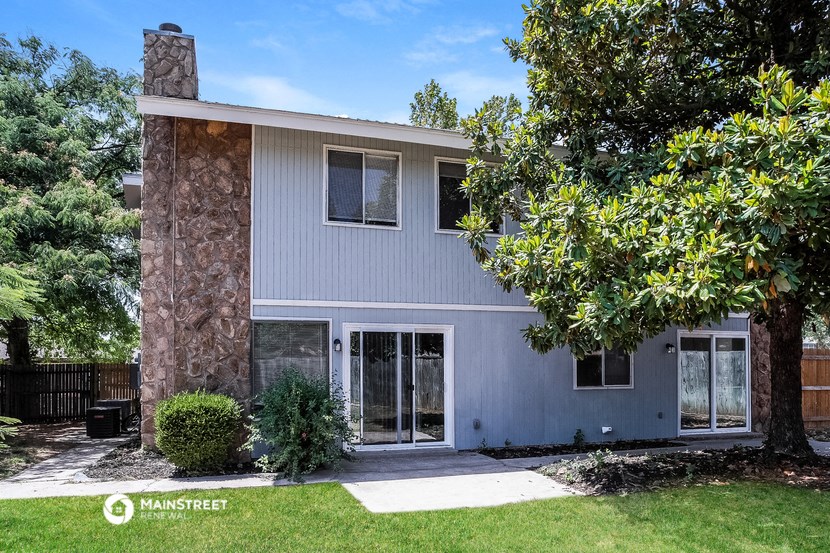 a white house with a tree in front of it