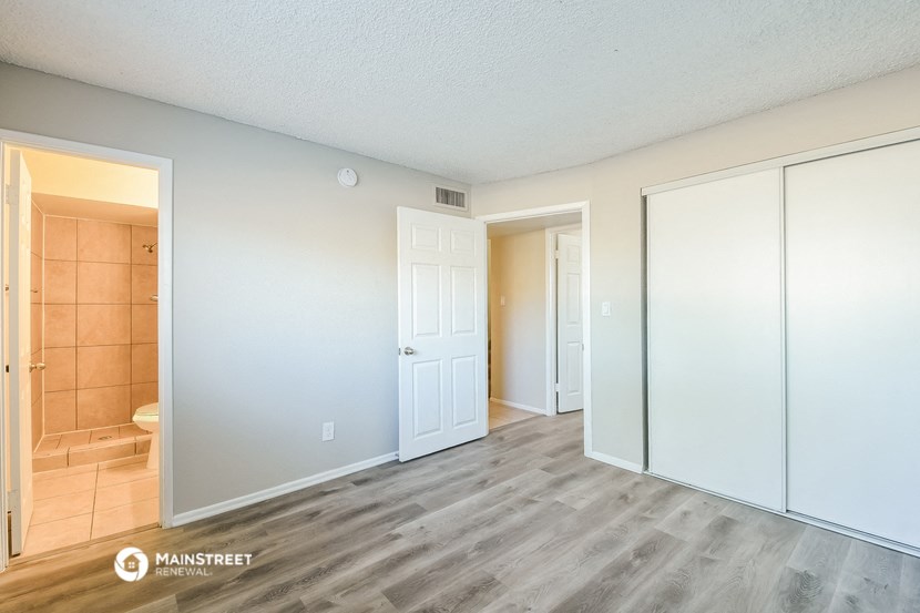 a renovated living room with white walls and wood flooring