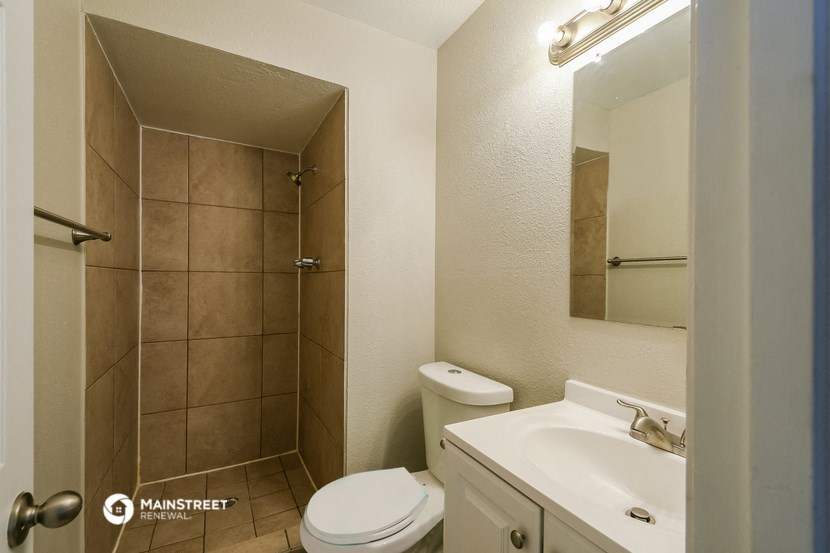 a bathroom with a shower toilet and sink