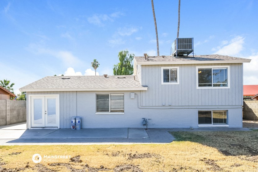 a white house with a driveway and a roof