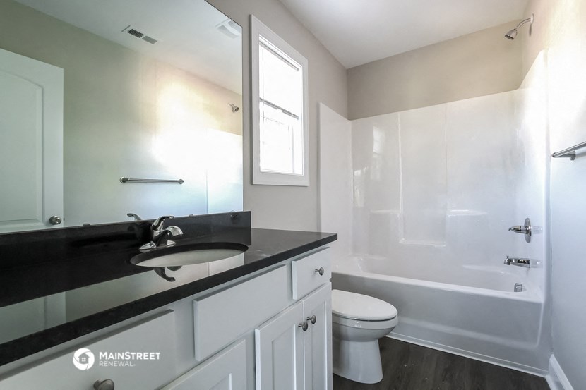 a bathroom with a sink and a toilet and a shower