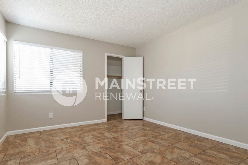 a room with a large window and a tile floor
