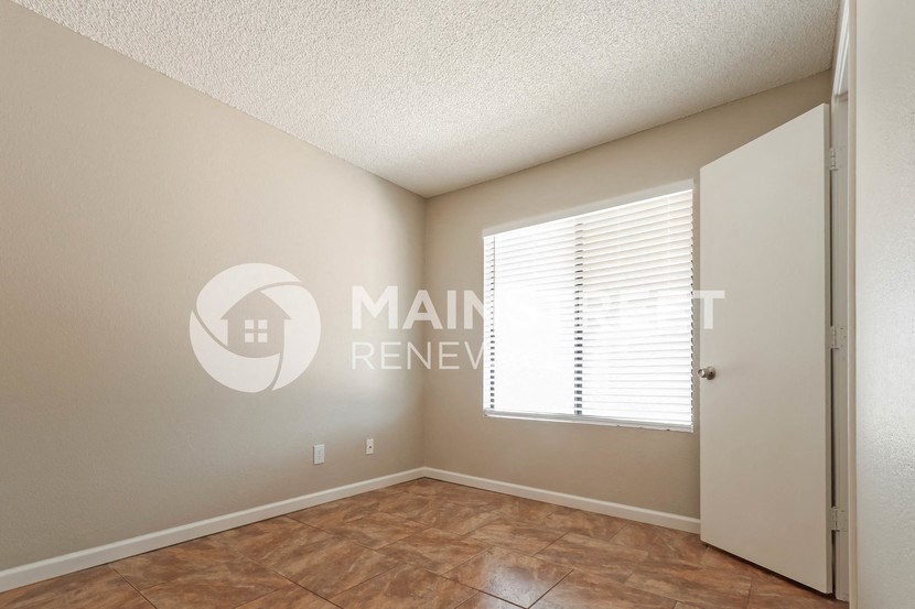 a bedroom with a closet and a window
