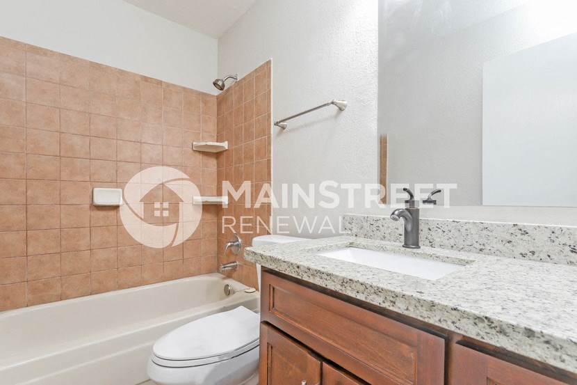 a bathroom with a sink toilet and a bath tub