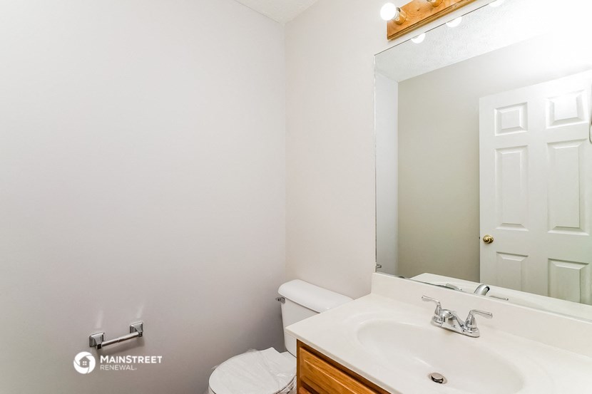 a bathroom with a sink and a mirror and a toilet