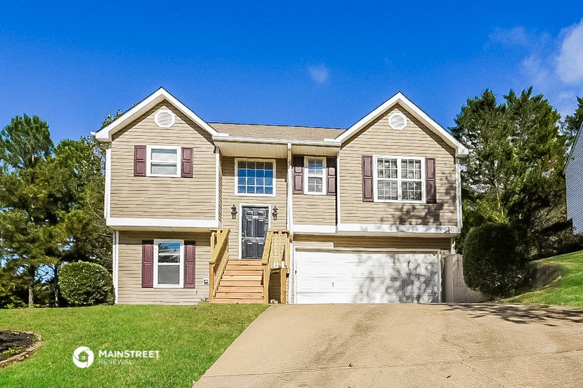 a tan house with a white garage door