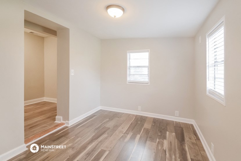 the spacious living room and dining room with hardwood flooring