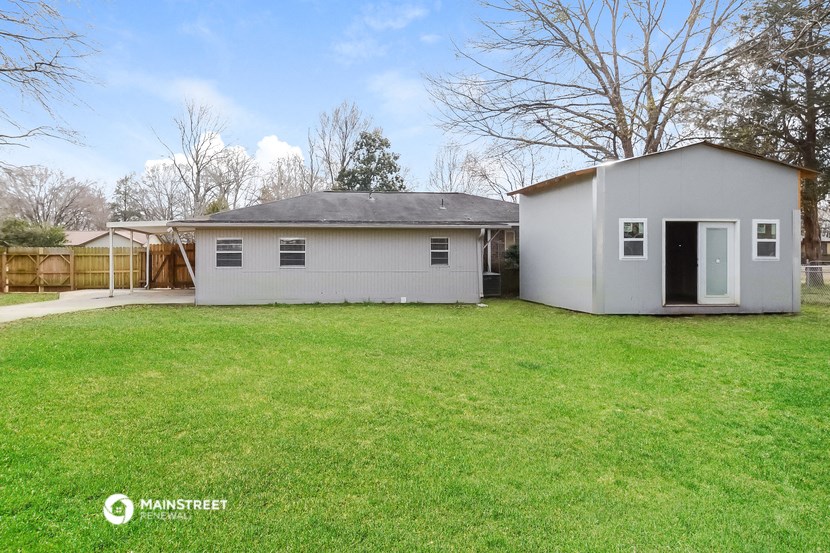 a white house with a grass yard and a backyard