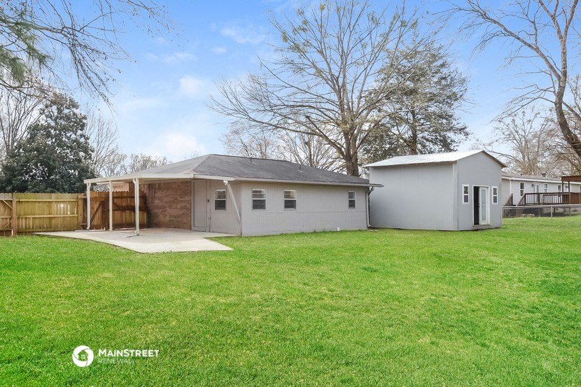 a backyard with a shed and a chicken coop