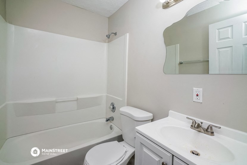 a white bathroom with a sink toilet and bath tub