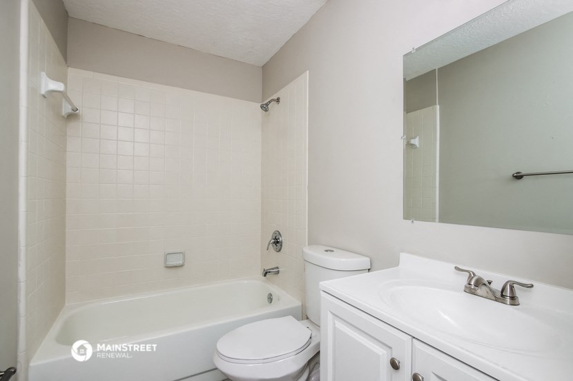 a bathroom with a sink toilet and a bath tub