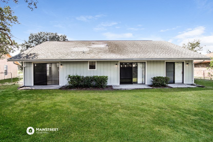 a white house with a yard and a lawn