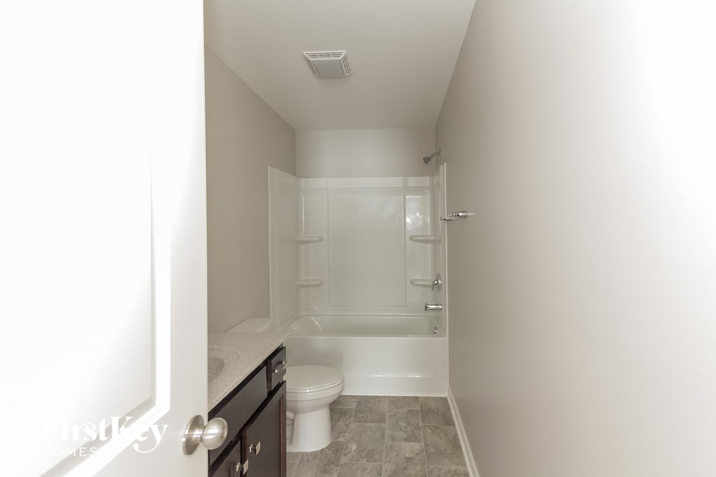 a small bathroom with a toilet and a shower