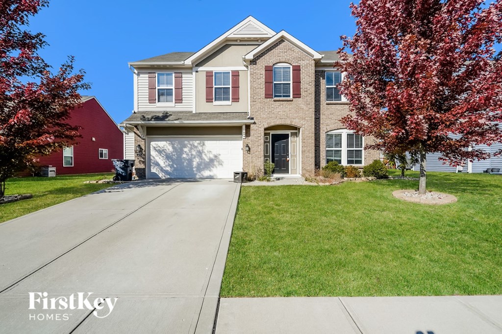 a large brick house with a white garage door