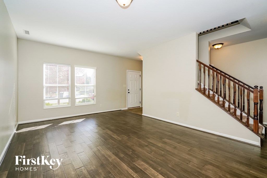 the living room is open to the dining room and kitchen