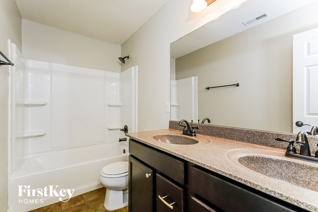 a bathroom with a sink and a toilet and a shower