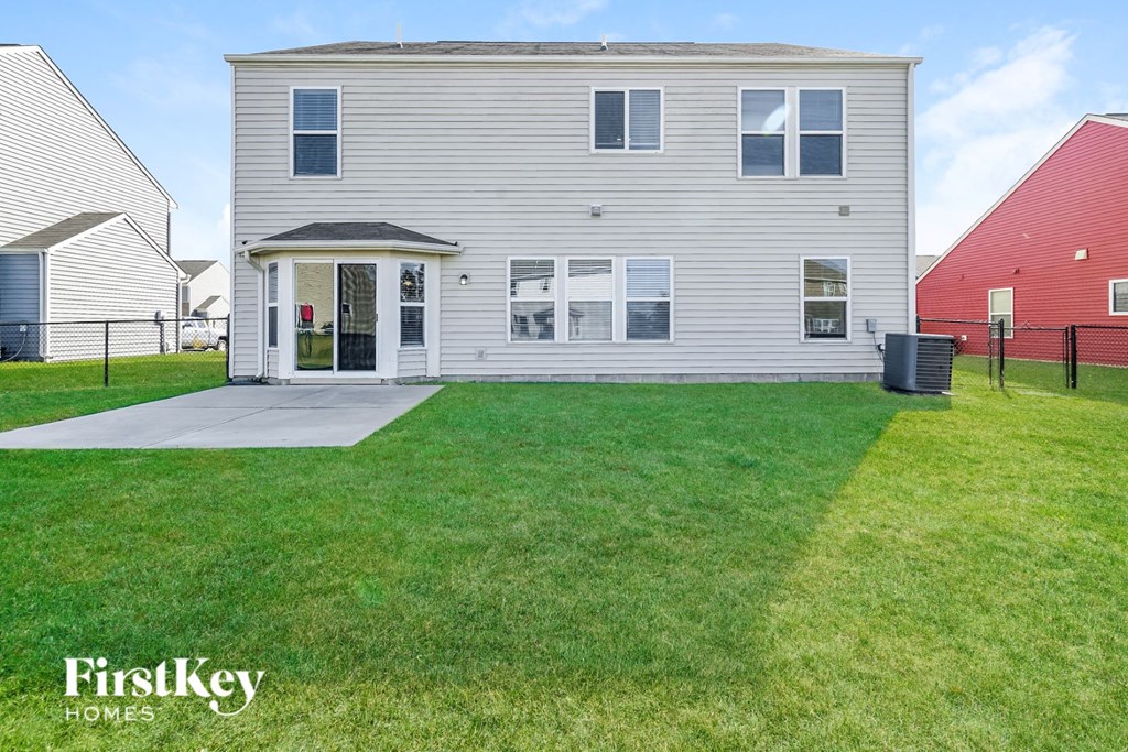 a white house with a yard in front of it