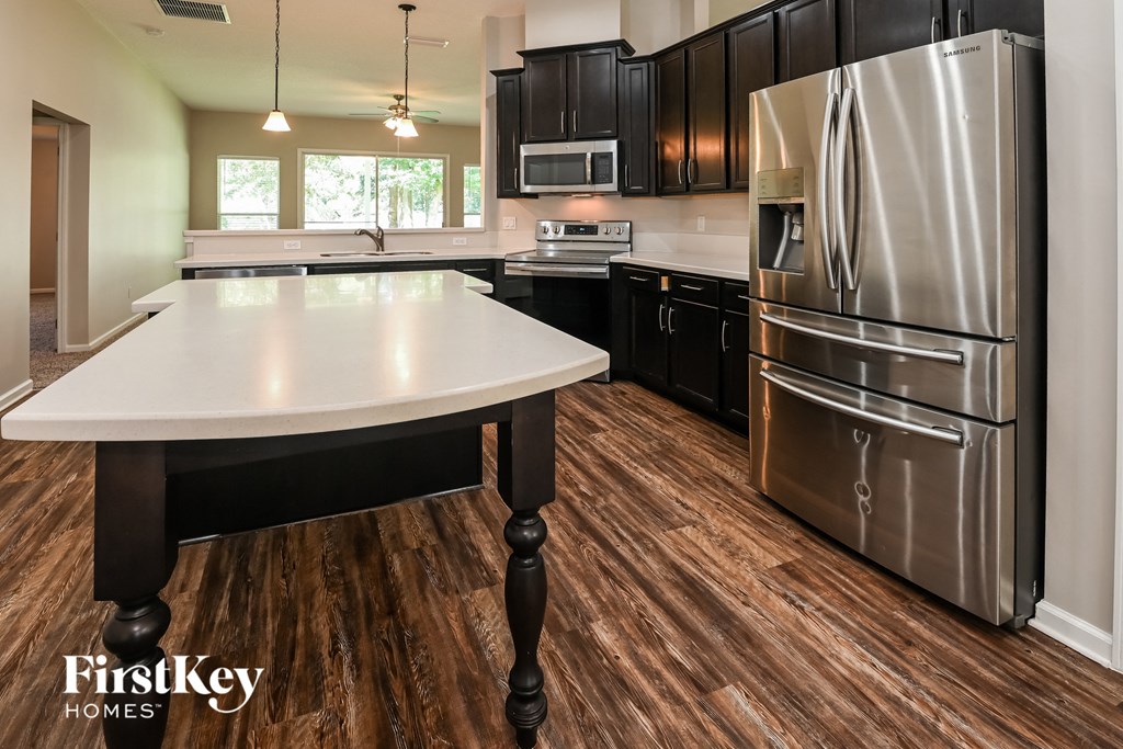 a kitchen with stainless steel appliances and a white counter top