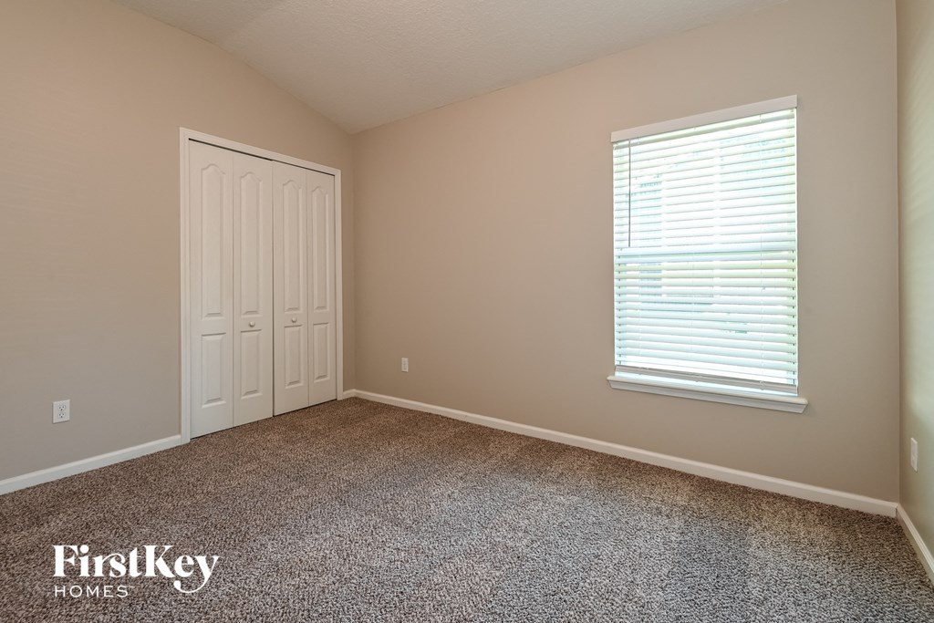 a room with carpet and a window and a door