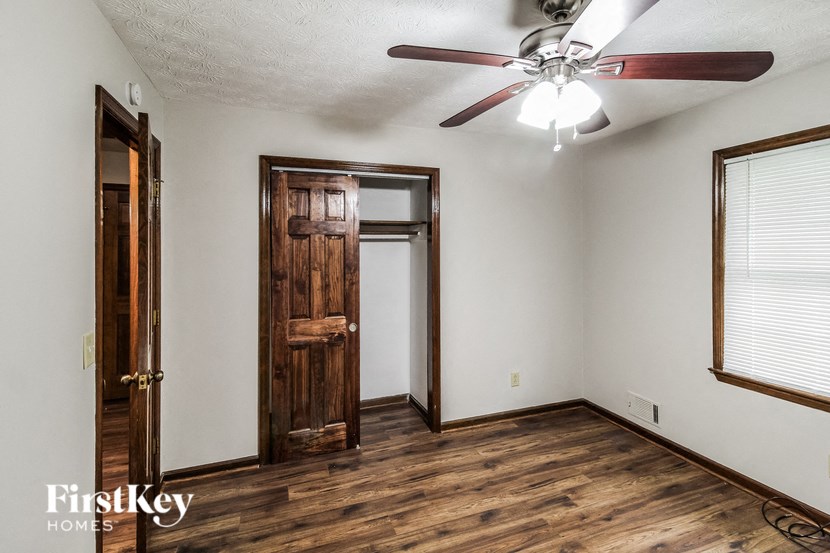 A room with a wooden floor and a ceiling fan.