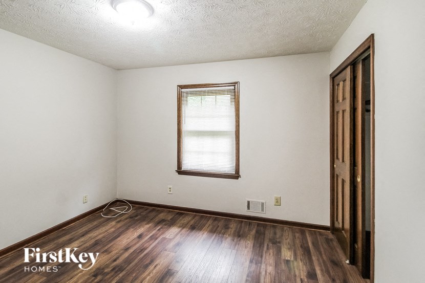 A room with wooden floors and a window.