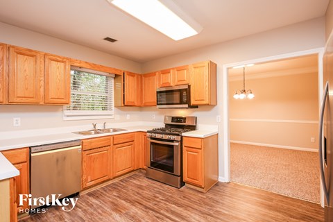 A kitchen with wooden cabinets and a refrigerator.