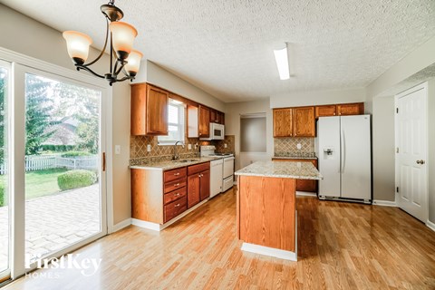 a kitchen with wooden cabinets and a white refrigerator
