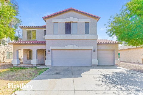 a beige house with a white garage door