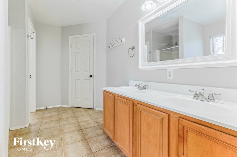 a bathroom with a sink and a mirror and a door