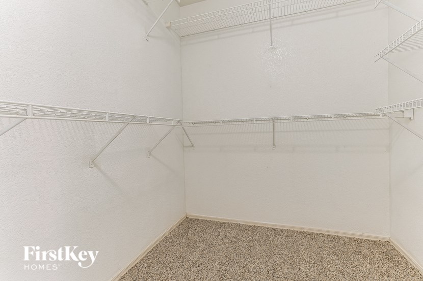 a empty room with white walls and shelves in a white closet