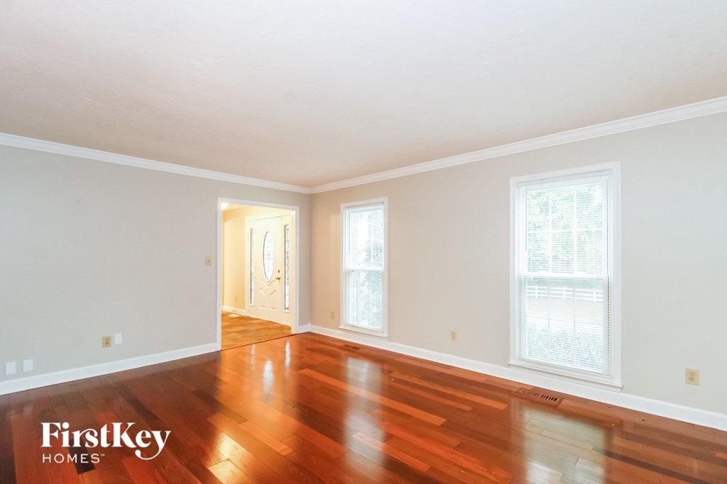 a living room with wood floors and white walls