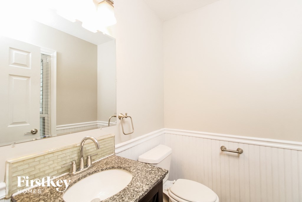 a bathroom with a sink and a toilet and a mirror