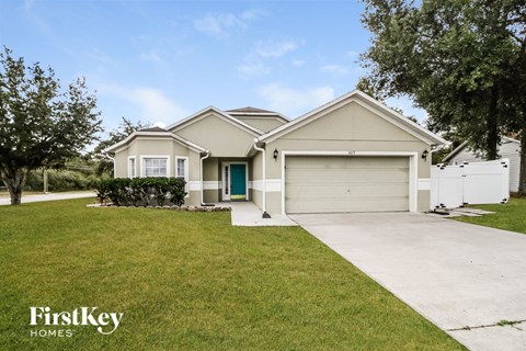 a white house with a driveway and a garage door