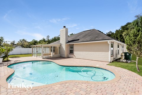a backyard with a pool and a house