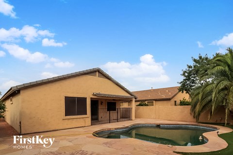 A house with a pool in the backyard.