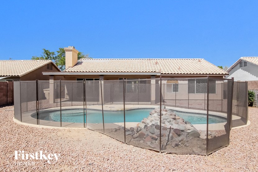 a hot tub enclosure with a pool in the backyard of a house
