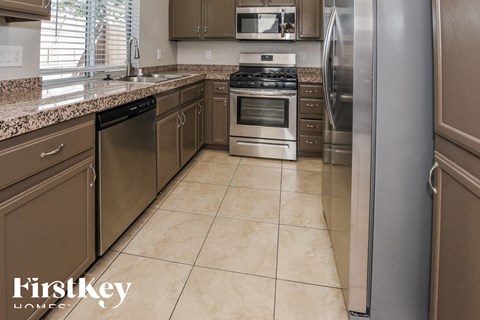 a kitchen with stainless steel appliances and granite counters