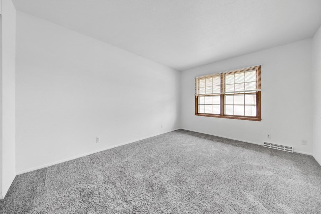 the living room of an empty house with a window
