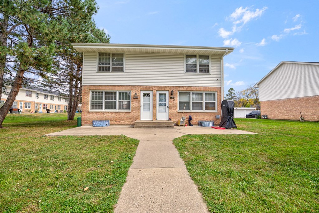 a white house with a walkway in front of it