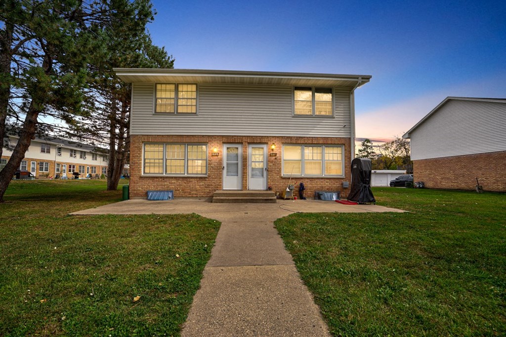 the front of a house with a walkway in front of it