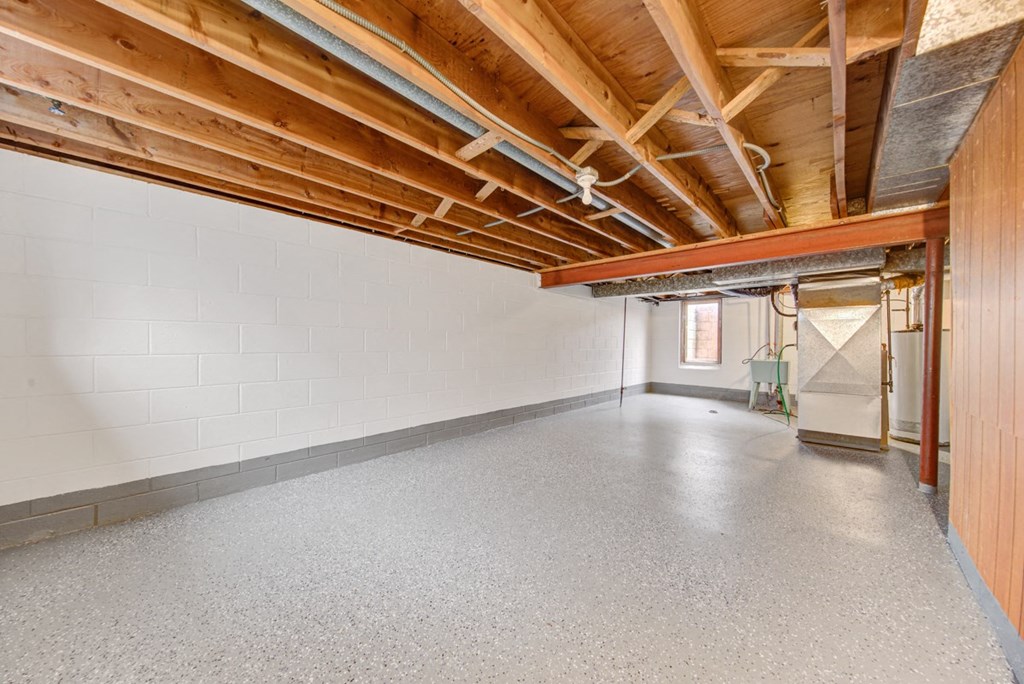a large room with concrete floors and wood ceilings